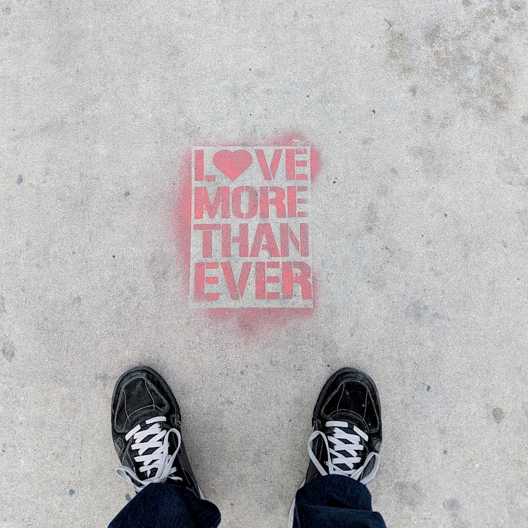 sidewalk art reading 'love more than ever'