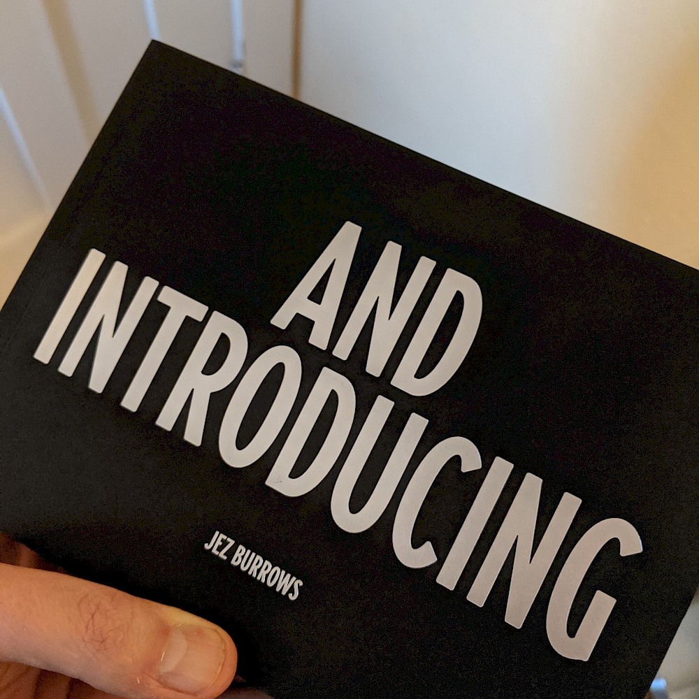 holding the book 'And Introducing' by Jez Burrows