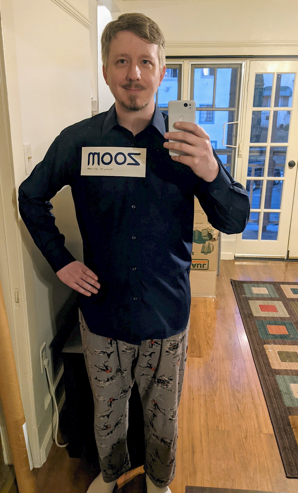 myself wearing a navy button-down shirt and pajama pants. Tag on my shirt has the Zoom logo and meeting ID: 867-5309
