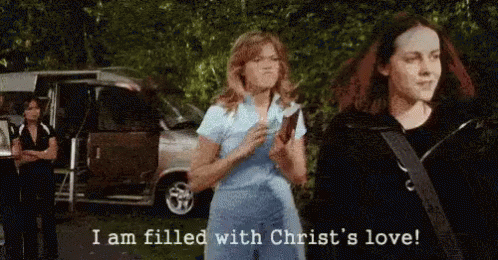 animated image of Mandy Moore in the movie 'Saved' throwing a Bible at her friend while yelling 'I am filled with Christ's love!'